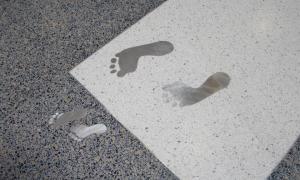 Metal human adult and child footprints in a floor