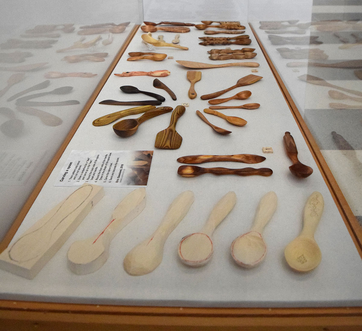 case displaying carved wooden spoons
